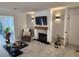 Cozy living room features a stone fireplace, mounted TV, and wood-look flooring at 1644 Alexandria Ct, Marietta, GA 30067