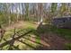 Backyard area featuring a grassy space, a Magnolia tree, and a storage building at 1767 Wingard Dr, Marietta, GA 30062