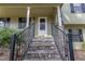 Inviting front porch with stone steps and iron railings, leading to the entrance of the home at 1767 Wingard Dr, Marietta, GA 30062