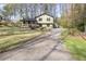 Charming two-story home with a long driveway and well-manicured lawn, nestled among mature trees at 1767 Wingard Dr, Marietta, GA 30062