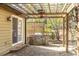 Back patio with wooden trellis, ceiling fan, built-in barbecue, and stone floor at 1767 Wingard Dr, Marietta, GA 30062