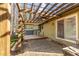 Back patio with wooden trellis, ceiling fan, stone floor, and exterior kitchen at 1767 Wingard Dr, Marietta, GA 30062
