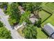 Aerial view of property with driveway, mature trees, and spacious yard, offering a private and serene living environment at 3260 Sims View Ct, Snellville, GA 30078