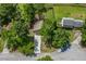 Aerial view of home with driveway and mature trees in a suburban setting, offering a blend of privacy and convenience at 3260 Sims View Ct, Snellville, GA 30078