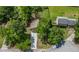 Home showcasing a driveway, mature trees, and surrounding greenery, located in a peaceful residential neighborhood at 3260 Sims View Ct, Snellville, GA 30078