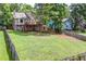Spacious backyard featuring a large deck, fenced in yard, and lush green grass at 3260 Sims View Ct, Snellville, GA 30078