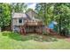 Expansive backyard view featuring a spacious deck, lush green lawn, and mature trees at 3260 Sims View Ct, Snellville, GA 30078