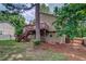 Backyard view of home's exterior, deck and stairs at 3260 Sims View Ct, Snellville, GA 30078