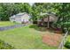 View of backyard, deck, fencing, mature trees, and green lawn, perfect for creating a private outdoor oasis at 3260 Sims View Ct, Snellville, GA 30078