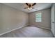 Neutral carpeted bedroom with a ceiling fan and a window at 3260 Sims View Ct, Snellville, GA 30078