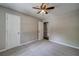 Neutral bedroom with carpet, ceiling fan, and interior doors at 3260 Sims View Ct, Snellville, GA 30078
