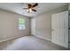Neutral carpeted bedroom with window and a ceiling fan at 3260 Sims View Ct, Snellville, GA 30078
