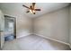 Neutral bedroom with carpet flooring, ceiling fan and door to another room at 3260 Sims View Ct, Snellville, GA 30078