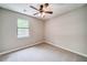 Carpeted bedroom with window and ceiling fan at 3260 Sims View Ct, Snellville, GA 30078
