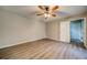 Bedroom featuring neutral walls, wood-look flooring, and a ceiling fan with lighting at 3260 Sims View Ct, Snellville, GA 30078
