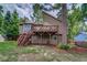 Exterior backyard view of a home with a deck, stairs and yard at 3260 Sims View Ct, Snellville, GA 30078