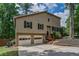 Inviting home exterior with a two car garage, driveway, and well-kept lawn at 3260 Sims View Ct, Snellville, GA 30078