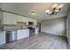 Renovated kitchen featuring stainless appliances, white cabinets, and luxury wood-style flooring at 3260 Sims View Ct, Snellville, GA 30078