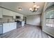 Updated kitchen featuring stainless appliances, white cabinets, and luxury wood-style flooring at 3260 Sims View Ct, Snellville, GA 30078
