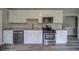 Well-equipped kitchen featuring stainless steel appliances, granite countertops, and white cabinetry at 3260 Sims View Ct, Snellville, GA 30078