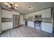 Updated kitchen featuring stainless steel appliances, white cabinets, and stone countertops at 3260 Sims View Ct, Snellville, GA 30078