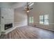 Inviting living room featuring a vaulted ceiling, cozy fireplace, and large windows that let in plenty of natural light at 3260 Sims View Ct, Snellville, GA 30078