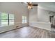 Bright living room with vaulted ceilings, large windows, and modern wood-look flooring at 3260 Sims View Ct, Snellville, GA 30078