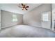 Spacious main bedroom with neutral colors, carpet flooring, ceiling fan and ensuite bath at 3260 Sims View Ct, Snellville, GA 30078