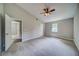 Spacious main bedroom featuring neutral colors, carpet flooring, ceiling fan and ensuite bath at 3260 Sims View Ct, Snellville, GA 30078