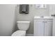 Functional half bathroom featuring a toilet, vanity, and towel rack at 34 Kelso At Peyton Dr, Atlanta, GA 30311