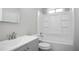 Spotless full bathroom with tub-shower combo, white fixtures, and storage space at 34 Kelso At Peyton Dr, Atlanta, GA 30311