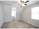 Bright bedroom with two windows, neutral carpet and a ceiling fan at 34 Kelso At Peyton Dr, Atlanta, GA 30311