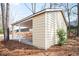 Backyard view of a carport with a concrete floor, light yellow siding and a view of the treelined backyard at 34 Kelso At Peyton Dr, Atlanta, GA 30311