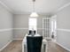 Charming dining area with white table, gray walls, and access to a door at 34 Kelso At Peyton Dr, Atlanta, GA 30311