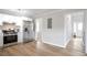 Bright kitchen showcasing stainless steel appliances, white cabinetry, and luxury vinyl plank flooring at 34 Kelso At Peyton Dr, Atlanta, GA 30311