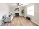 Bright living room featuring light walls, wood floors, a fireplace, and a large window for ample natural light at 34 Kelso At Peyton Dr, Atlanta, GA 30311