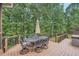 Outdoor wooden deck featuring an umbrella-covered table and seating area, perfect for entertaining at 3270 New University Trl, Cumming, GA 30041