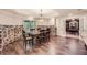 Elegant dining area with stone accents, wood floors, and a view into the office through glass paned doors at 3270 New University Trl, Cumming, GA 30041