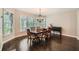 Dining room with dark wood flooring, chandelier, lots of natural light and traditional wood table at 3270 New University Trl, Cumming, GA 30041