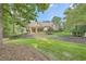 Well-manicured front lawn with mature trees accentuates the attractive facade of this home at 3270 New University Trl, Cumming, GA 30041