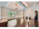 Bright foyer featuring hardwood floors, white pillars and trim, chandelier, and natural light at 3270 New University Trl, Cumming, GA 30041