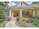 Inviting front porch with stone details and comfortable seating, perfect for relaxing outdoors at 3270 New University Trl, Cumming, GA 30041