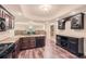 Open-concept basement kitchen with granite counters, wine storage, and modern appliances at 3270 New University Trl, Cumming, GA 30041