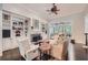 Cozy living room with a stone fireplace, built-in shelving, and hardwood floors at 3270 New University Trl, Cumming, GA 30041