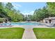 Beautiful community pool area with lounge chairs, gazebos, and well-maintained landscaping at 3270 New University Trl, Cumming, GA 30041