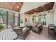 Relaxing screened porch featuring wicker furniture, wood ceiling, and ample seating at 3270 New University Trl, Cumming, GA 30041