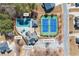 Aerial view shows the pool, jacuzzi, clubhouse, and tennis courts at 3316 Quarter Horse Ln, Conyers, GA 30013