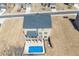 Aerial view of backyard pool, deck, and house with neutral siding and black shutters, surrounded by a dry lawn at 3316 Quarter Horse Ln, Conyers, GA 30013