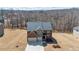 Aerial view of the brick home, driveway and large yard, with leafless trees and cloudy blue sky at 3316 Quarter Horse Ln, Conyers, GA 30013