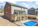 A view of the backyard featuring a pool, covered patio, and second-story deck with a beautiful home exterior at 3316 Quarter Horse Ln, Conyers, GA 30013